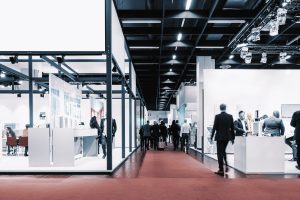 business people walking between trade show booths. ideal for web